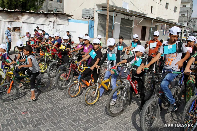 Palestinian children take part in the bicycles marathon to demand their right to play and break the siege on Gaza strip, in Rafah in the southern Gaza Strip. on August 7, 2016. Photo by Abed Rahim Khatib