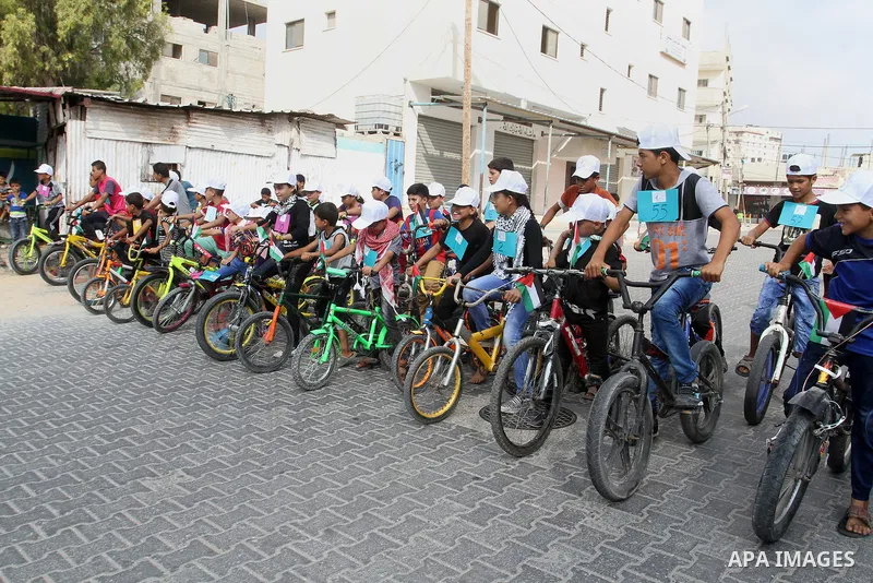 Palestinian children take part in the bicycles marathon to demand their right to play and break the siege on Gaza strip, in Rafah in the southern Gaza Strip. on August 7, 2016. Photo by Abed Rahim Khatib