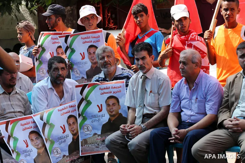 Supporters of the Popular Front for the Liberation of Palestine (PFLP) take part in a protest demanding for the release of Bilal Kayed a Palestinian prisoner on hunger strike, in front of Red cross office, in Gaza city o...
