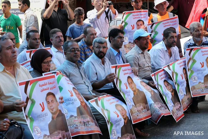 Supporters of the Popular Front for the Liberation of Palestine (PFLP) take part in a protest demanding for the release of Bilal Kayed a Palestinian prisoner on hunger strike, in front of Red cross office, in Gaza city o...