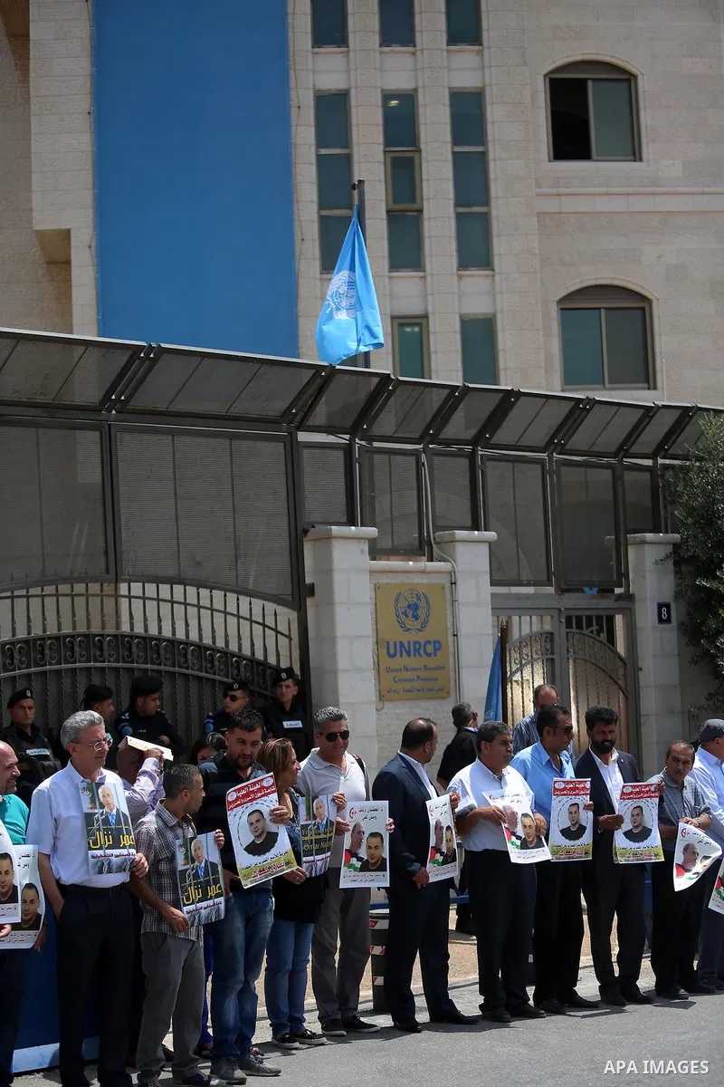 Palestinians take part during a protest calling for the release of Palestinian journalist Omar Nazzal and Bilal Kayed a Palestinian prisoner on hunger strike, in front of UN headquarters in the West Bank city of Ramallah...