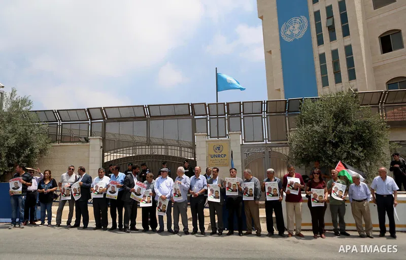 Palestinians take part during a protest calling for the release of Palestinian journalist Omar Nazzal and Bilal Kayed a Palestinian prisoner on hunger strike, in front of UN headquarters in the West Bank city of Ramallah...