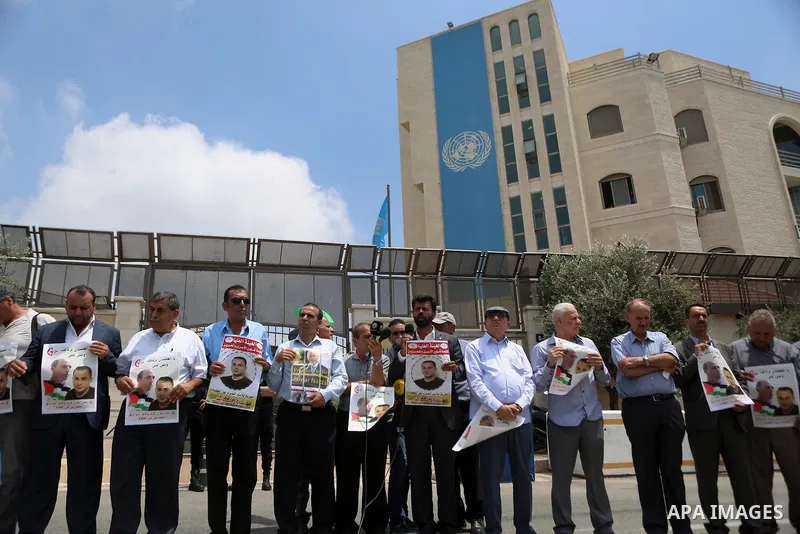 Palestinians take part during a protest calling for the release of Palestinian journalist Omar Nazzal and Bilal Kayed a Palestinian prisoner on hunger strike, in front of UN headquarters in the West Bank city of Ramallah...