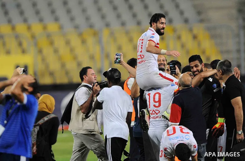 Zamalek players celebrate with the trophy after winning their Egyptian Cup finals derby soccer match against Al Ahly in Borg El-Arab Stadium near Alexandria, Egypt, Aug 8,2016. Photo by Stringer