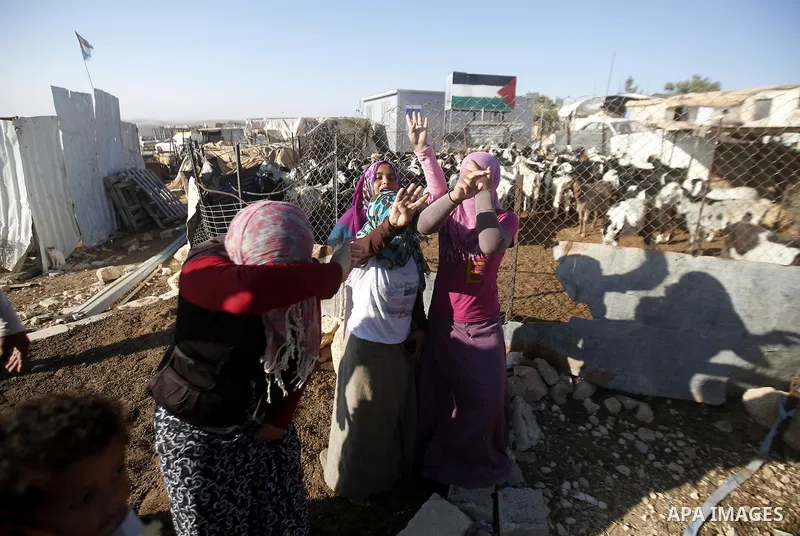 Palestinians check their belongings after Israeli troops demolished their shed near the West Bank village of Um AlKhair, south of Hebron August 9, 2016. Photo by Wisam Hashlamoun