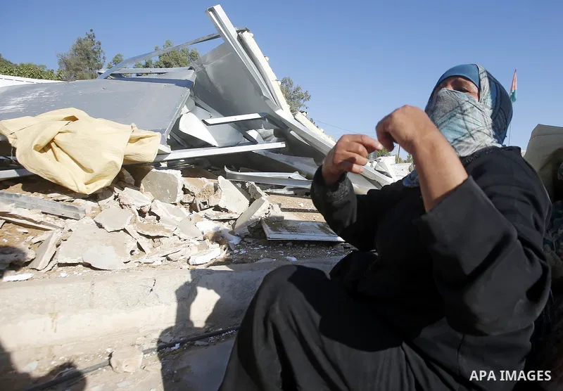 Palestinians check their belongings after Israeli troops demolished their shed near the West Bank village of Um AlKhair, south of Hebron August 9, 2016. Photo by Wisam Hashlamoun