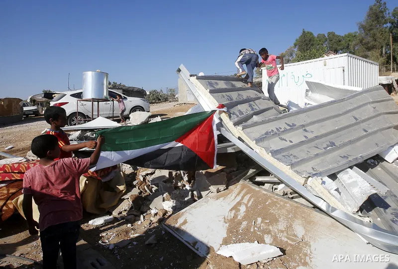 Palestinians check their belongings after Israeli troops demolished their shed near the West Bank village of Um AlKhair, south of Hebron August 9, 2016. Photo by Wisam Hashlamoun