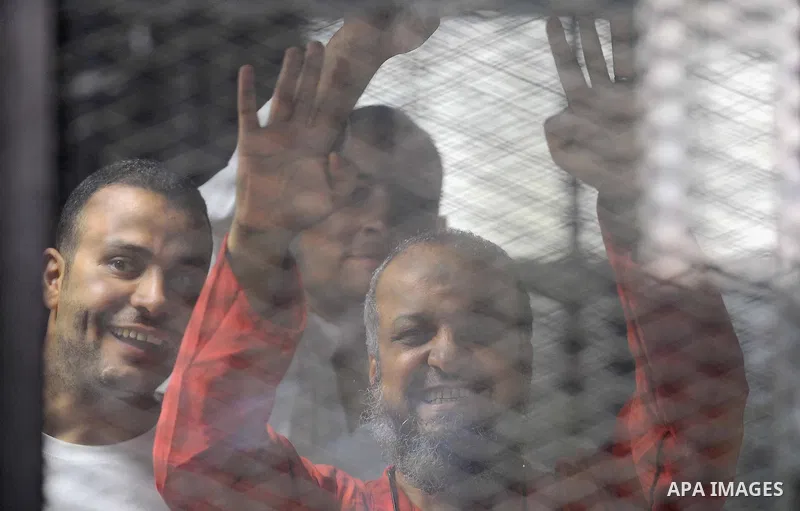 Egyptian Muslim Brotherhood defendants are seen behind bars during their trial, in a case known in media as "Rabaa Operations Room", in Cairo, on Aug. 09, 2016. Photo by Amr Sayed