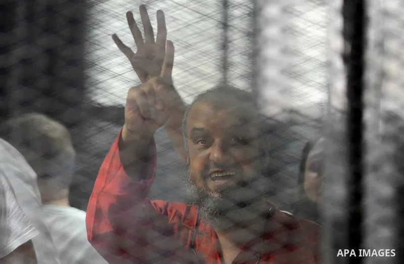 Egyptian Muslim Brotherhood defendants are seen behind bars during their trial, in a case known in media as "Rabaa Operations Room", in Cairo, on Aug. 09, 2016. Photo by Amr Sayed