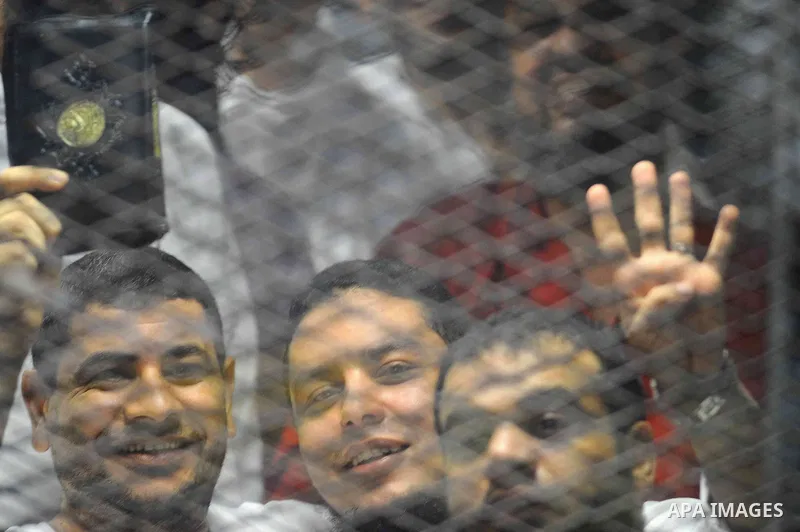 Egyptian Muslim Brotherhood defendants are seen behind bars during their trial, in a case known in media as "Rabaa Operations Room", in Cairo, on Aug. 09, 2016. Photo by Amr Sayed
