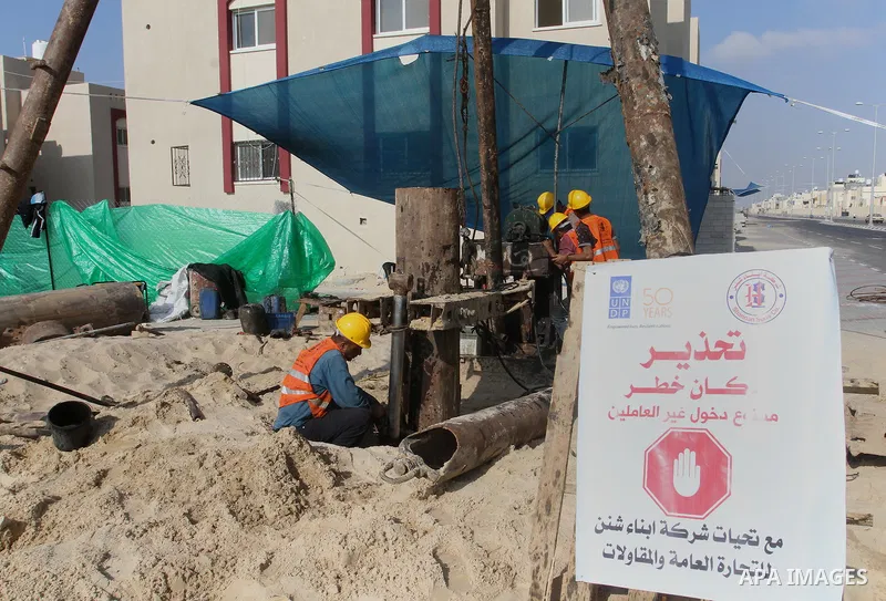 Palestinian workers work at project executed by the United Nations Development Programme (UNDP), in Rafah in the southern Gaza strip, on Aug. 09, 2016. Israel said it had arrested and charged a United Nations employee fo...