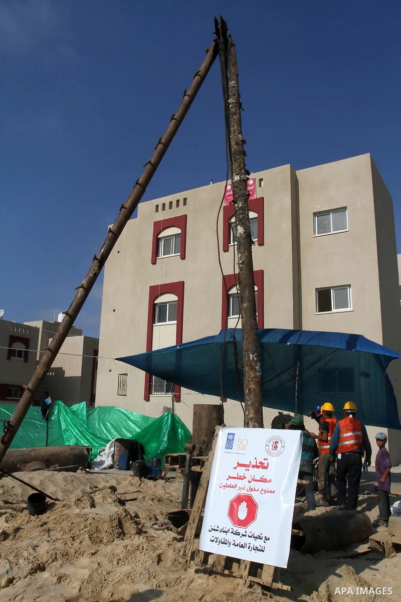 Palestinian workers work at project executed by the United Nations Development Programme (UNDP), in Rafah in the southern Gaza strip, on Aug. 09, 2016. Israel said it had arrested and charged a United Nations employee fo...