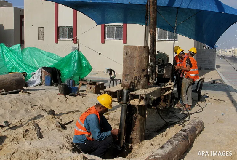 Palestinian workers work at project executed by the United Nations Development Programme (UNDP), in Rafah in the southern Gaza strip, on Aug. 09, 2016. Israel said it had arrested and charged a United Nations employee fo...