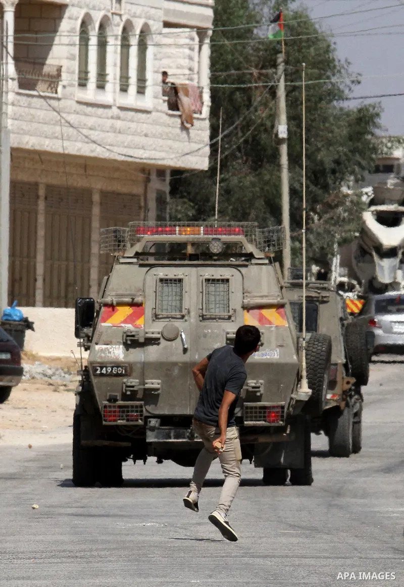 Palestinian protestors clash with Israeli soldiers in the village of Qusra on August 9, 2016 in the occupied West Bank. Qusra is just a few kilometres (miles) north of the Israeli settlement of Esh Kodesh and is the scen...