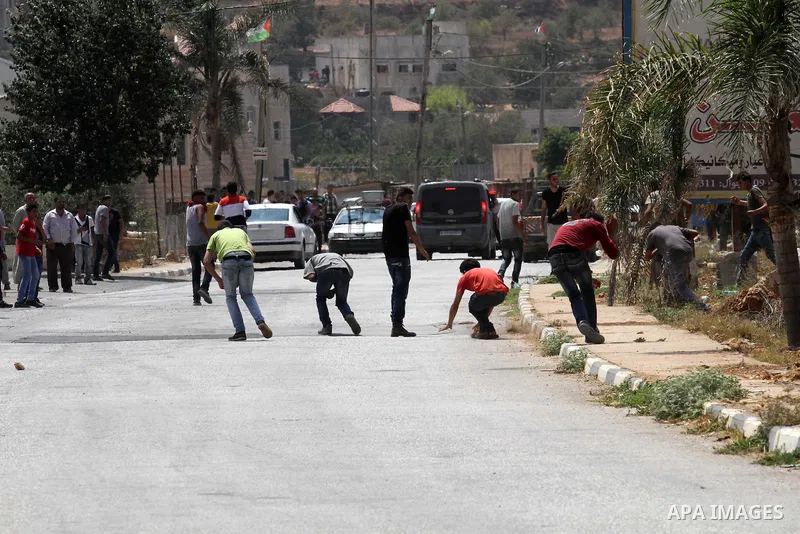 Palestinian protestors clash with Israeli soldiers in the village of Qusra on August 9, 2016 in the occupied West Bank. Qusra is just a few kilometres (miles) north of the Israeli settlement of Esh Kodesh and is the scen...