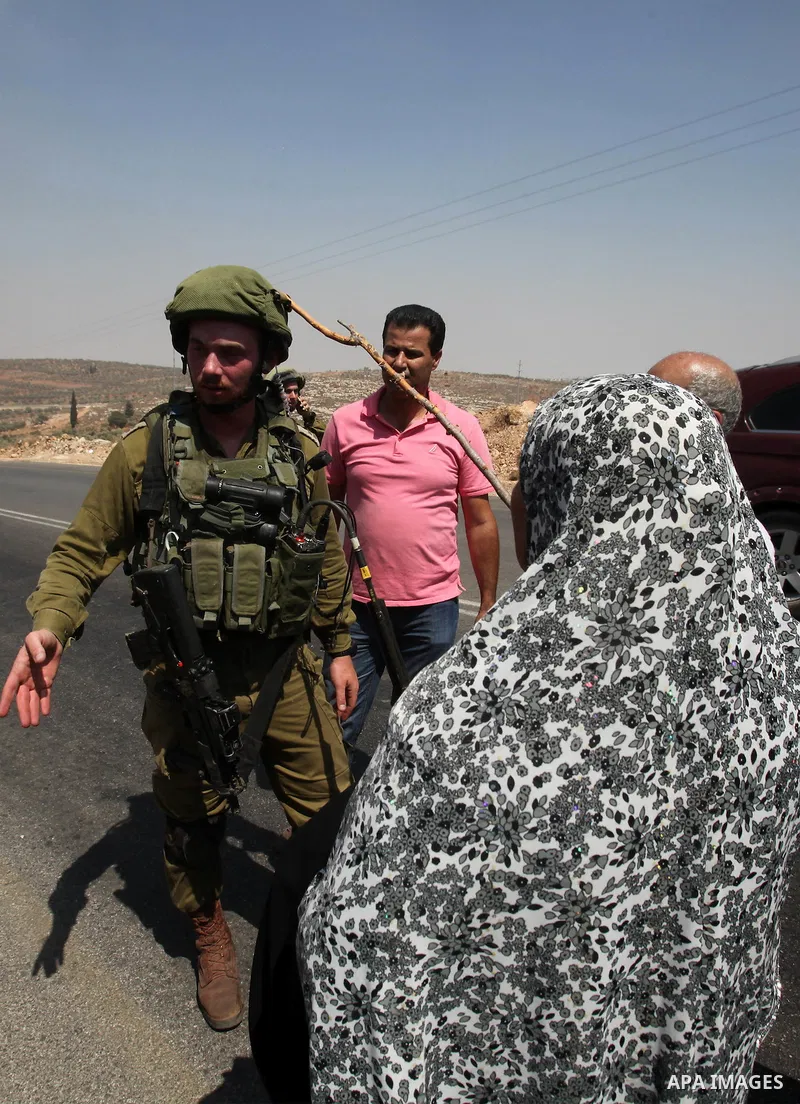 A Palestinian woman argues with an Israeli soldier during clashes with Palestinian youths in the village of Qusra on August 9, 2016 in the occupied West Bank. Qusra is just a few kilometres (miles) north of the Israeli s...