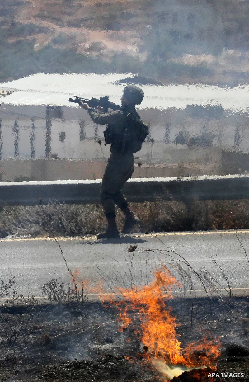 Israeli soldiers take position during clashes with Palestinian protestors in the village of Qusra on August 9, 2016 in the occupied West Bank. Qusra is just a few kilometres (miles) north of the Israeli settlement of Esh...