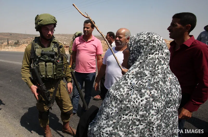 A Palestinian woman argues with an Israeli soldier during clashes with Palestinian youths in the village of Qusra on August 9, 2016 in the occupied West Bank. Qusra is just a few kilometres (miles) north of the Israeli s...
