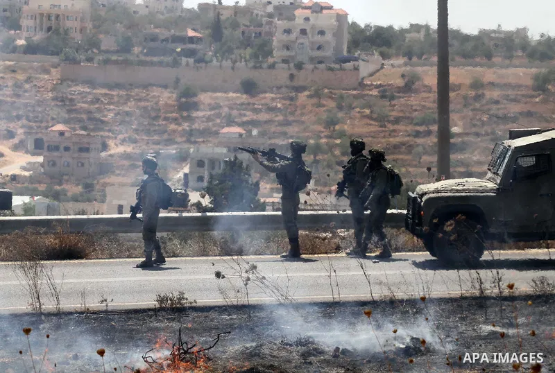 Israeli soldiers take position during clashes with Palestinian protestors in the village of Qusra on August 9, 2016 in the occupied West Bank. Qusra is just a few kilometres (miles) north of the Israeli settlement of Esh...