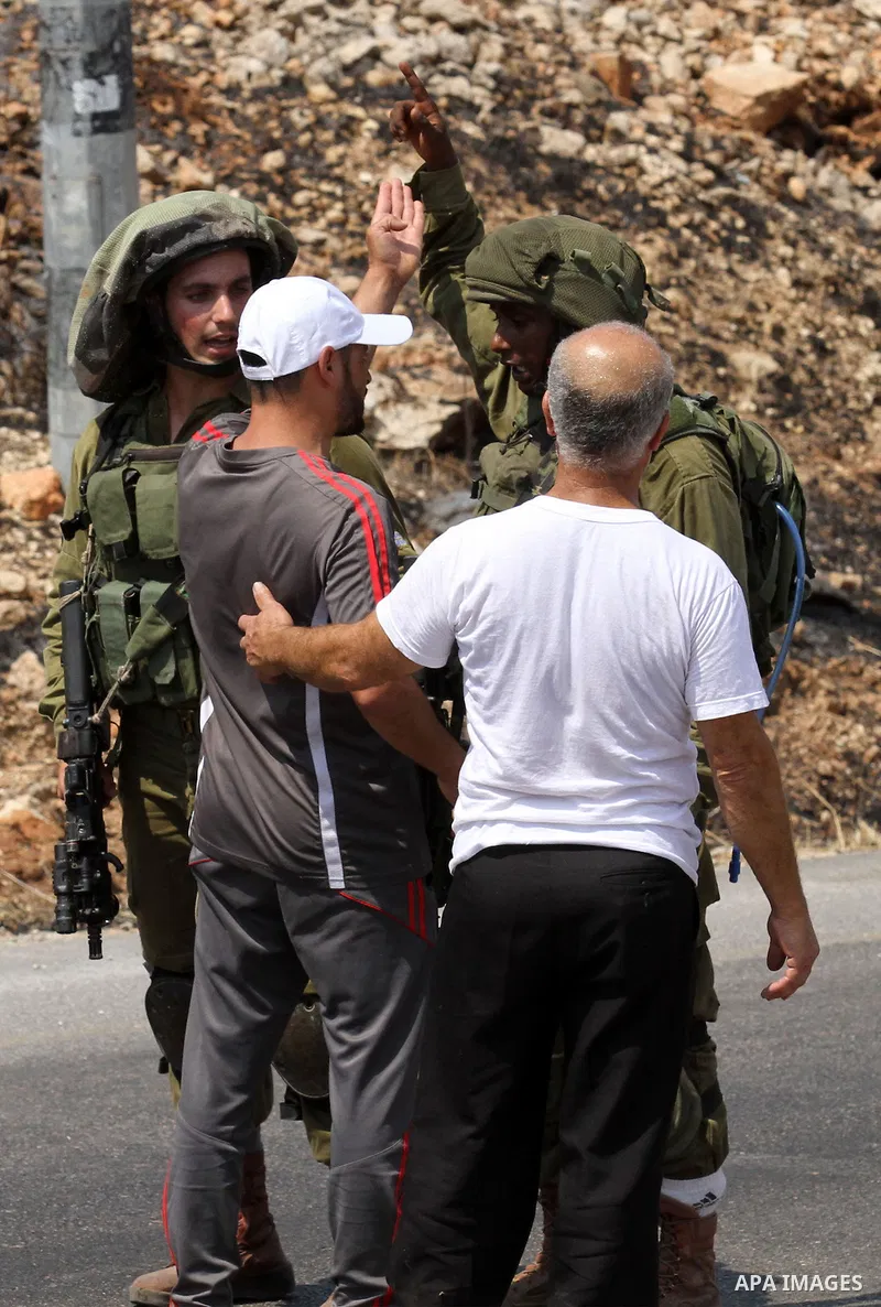 A Palestinian man argues with an Israeli soldier during clashes with Palestinian youths in the village of Qusra on August 9, 2016 in the occupied West Bank. Qusra is just a few kilometres (miles) north of the Israeli set...