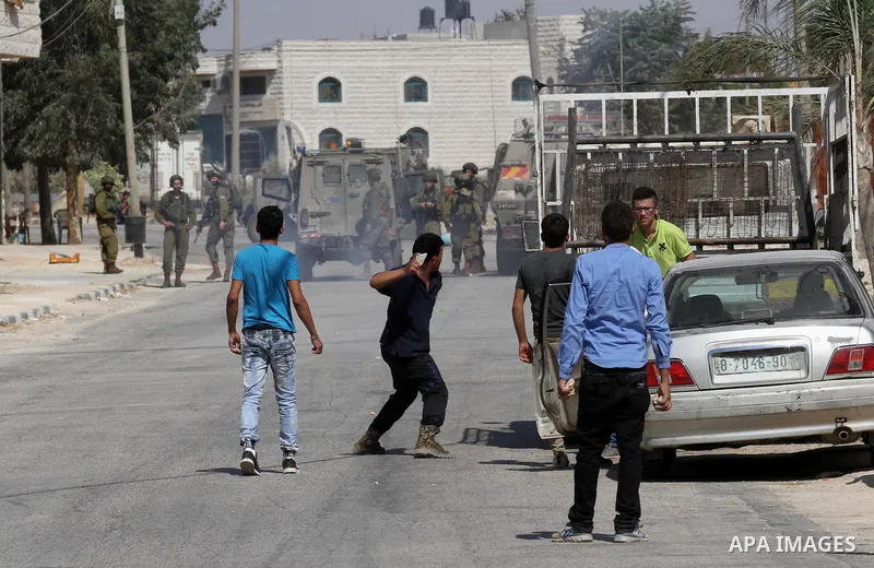 Palestinian protestors clash with Israeli soldiers in the village of Qusra on August 9, 2016 in the occupied West Bank. Qusra is just a few kilometres (miles) north of the Israeli settlement of Esh Kodesh and is the scen...