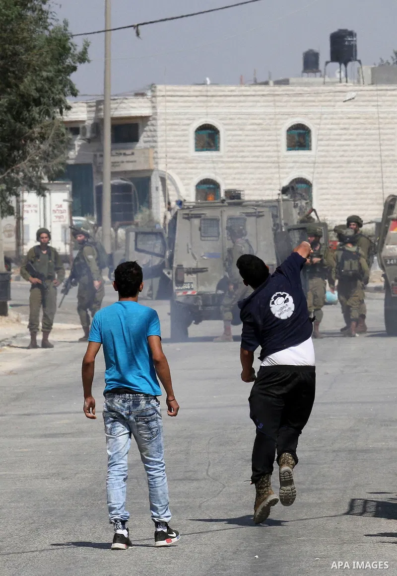 Palestinian protestors clash with Israeli soldiers in the village of Qusra on August 9, 2016 in the occupied West Bank. Qusra is just a few kilometres (miles) north of the Israeli settlement of Esh Kodesh and is the scen...