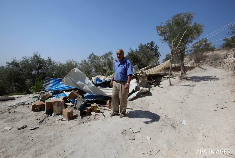 A Palestinian inspects the rubble of his restaurant after it was demolished by Israeli troops in the village of Sabastya near the West Bank city of Nablus, on Aug. 9, 2016. Israeli authorities demolished a restaurant and...