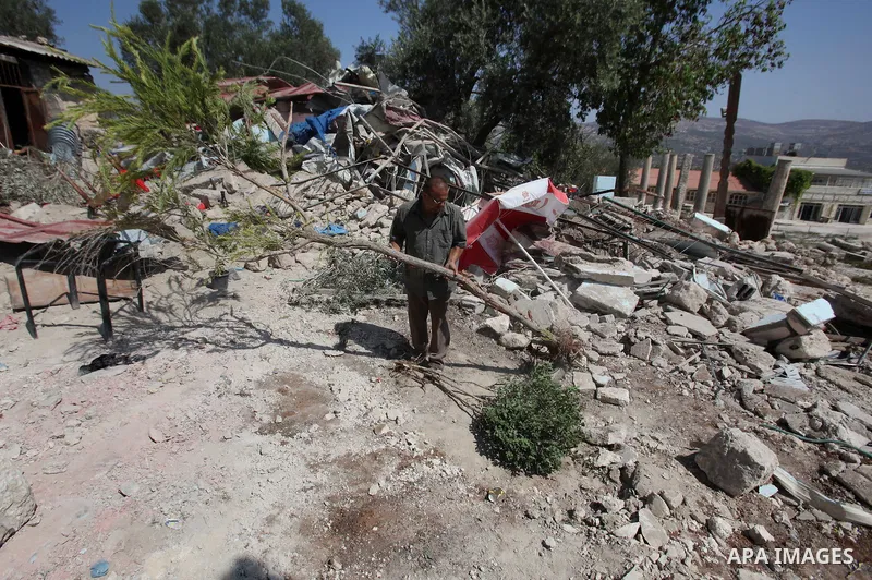 A Palestinian inspects the rubble of his restaurant after it was demolished by Israeli troops in the village of Sabastya near the West Bank city of Nablus, on Aug. 9, 2016. Israeli authorities demolished a restaurant and...