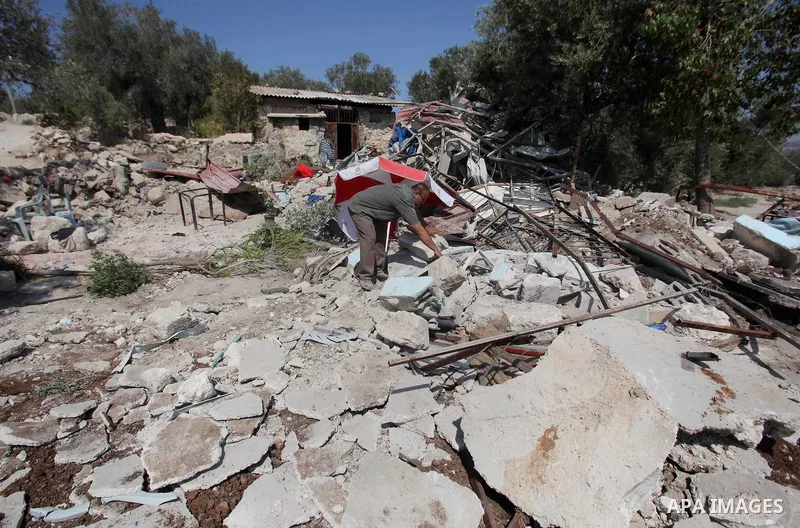 A Palestinian inspects the rubble of his restaurant after it was demolished by Israeli troops in the village of Sabastya near the West Bank city of Nablus, on Aug. 9, 2016. Israeli authorities demolished a restaurant and...
