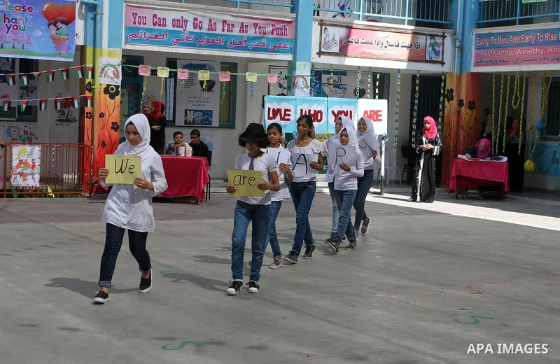 Palestinian schoolgirls take part in the closing ceremony of 2016 summer fun week organised by the United Nations Relief and Works Agency (UNRWA), in Rafah in the southern Gaza strip, on August 10, 2016. Photo by Abed Ra...