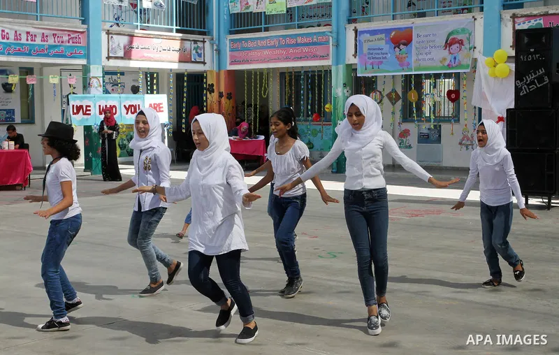 Palestinian schoolgirls take part in the closing ceremony of 2016 summer fun week organised by the United Nations Relief and Works Agency (UNRWA), in Rafah in the southern Gaza strip, on August 10, 2016. Photo by Abed Ra...