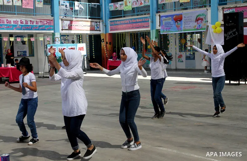 Palestinian schoolgirls take part in the closing ceremony of 2016 summer fun week organised by the United Nations Relief and Works Agency (UNRWA), in Rafah in the southern Gaza strip, on August 10, 2016. Photo by Abed Ra...