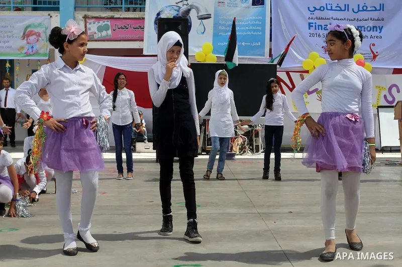 Palestinian schoolgirls take part in the closing ceremony of 2016 summer fun week organised by the United Nations Relief and Works Agency (UNRWA), in Rafah in the southern Gaza strip, on August 10, 2016. Photo by Abed Ra...