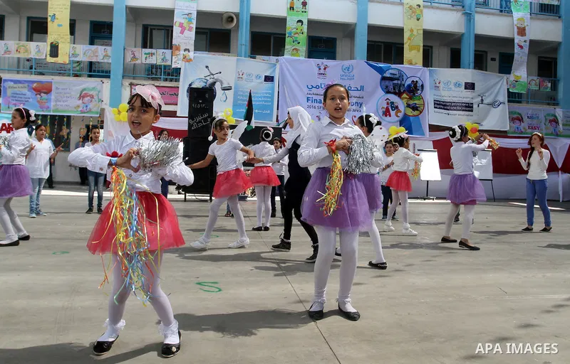 Palestinian schoolgirls take part in the closing ceremony of 2016 summer fun week organised by the United Nations Relief and Works Agency (UNRWA), in Rafah in the southern Gaza strip, on August 10, 2016. Photo by Abed Ra...
