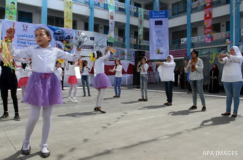 Palestinian schoolgirls take part in the closing ceremony of 2016 summer fun week organised by the United Nations Relief and Works Agency (UNRWA), in Rafah in the southern Gaza strip, on August 10, 2016. Photo by Abed Ra...