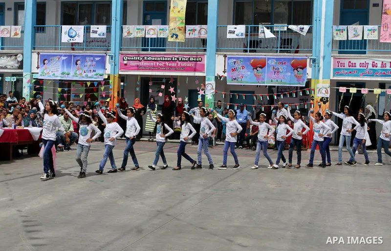 Palestinian schoolgirls take part in the closing ceremony of 2016 summer fun week organised by the United Nations Relief and Works Agency (UNRWA), in Rafah in the southern Gaza strip, on August 10, 2016. Photo by Abed Ra...