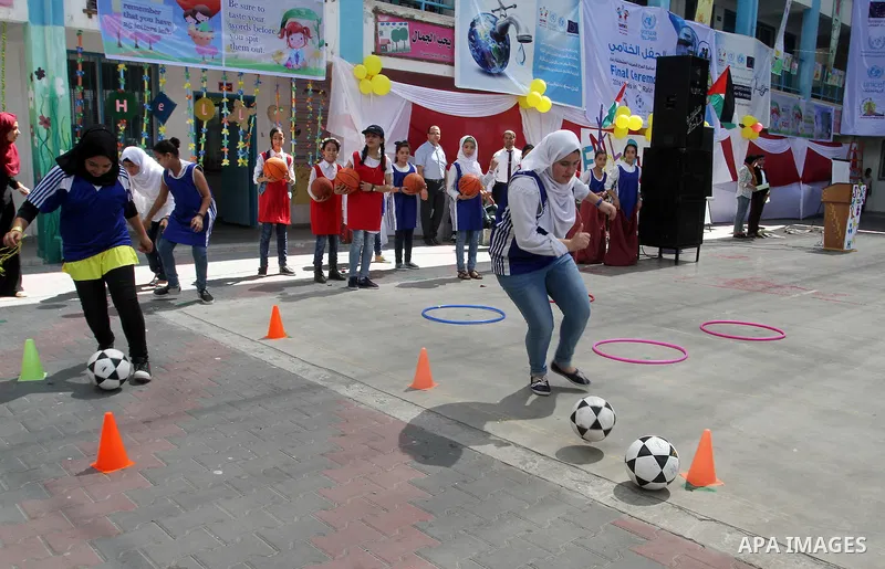 Palestinian schoolgirls take part in the closing ceremony of 2016 summer fun week organised by the United Nations Relief and Works Agency (UNRWA), in Rafah in the southern Gaza strip, on August 10, 2016. Photo by Abed Ra...