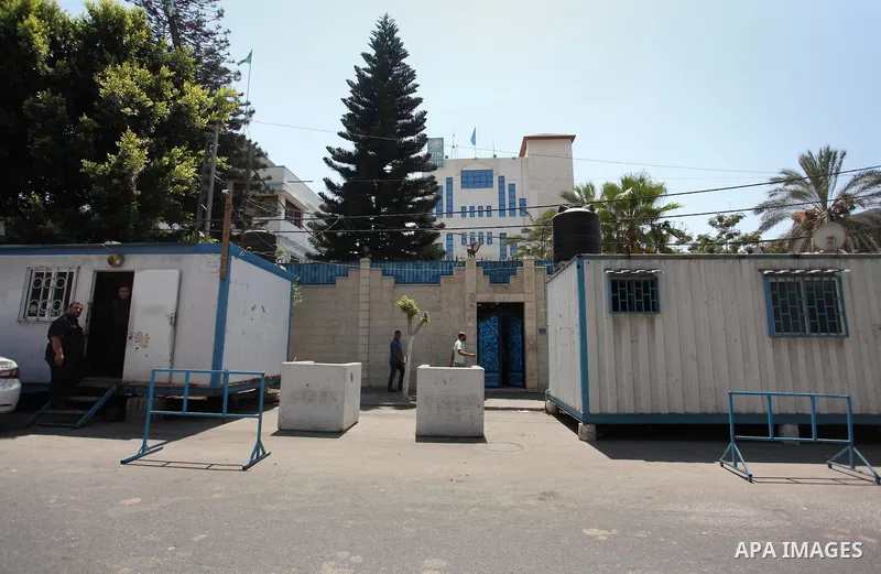 Palestinian staff of the United Nations Development Programme (UNDP) are seen in front of its headquarters in Gaza City on August 10, 2016. Israel said it had arrested and charged a United Nations employee for allegedly...