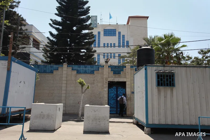 Palestinian staff of the United Nations Development Programme (UNDP) are seen in front of its headquarters in Gaza City on August 10, 2016. Israel said it had arrested and charged a United Nations employee for allegedly...