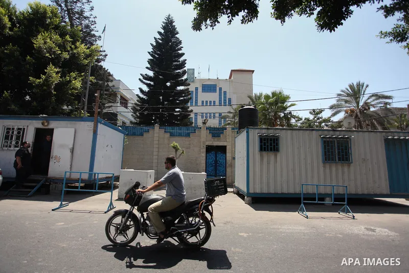 A Palestinian man rides a motorcycle in front of its headquarters in Gaza City on August 10, 2016. Israel said it had arrested and charged a United Nations employee for allegedly aiding Islamist movement Hamas, in the se...