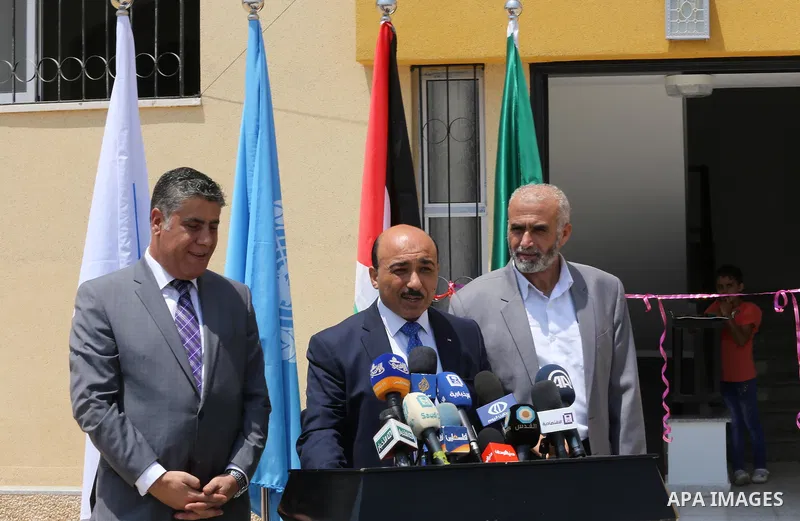 Palestinian Minister of public works and housing, Mofeed al-Hasayna, speaks during a distribution ceremony the 40 housing units funded by the Saudi Fund for the Palestinians, whose house was destroyed by what witnesses s...