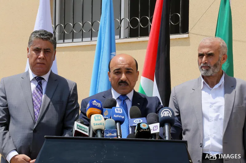 Palestinian Minister of public works and housing, Mofeed al-Hasayna, speaks during a distribution ceremony the 40 housing units funded by the Saudi Fund for the Palestinians, whose house was destroyed by what witnesses s...
