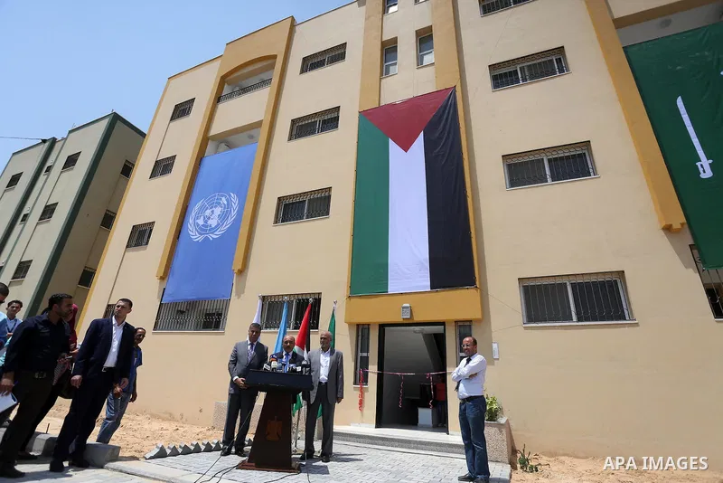 Palestinian Minister of public works and housing, Mofeed al-Hasayna, speaks during a distribution ceremony the 40 housing units funded by the Saudi Fund for the Palestinians, whose house was destroyed by what witnesses s...