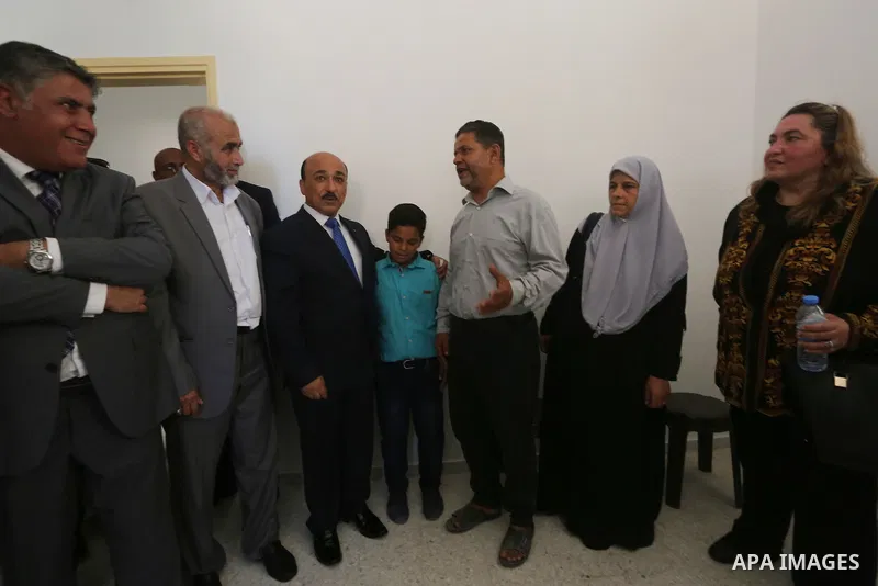 Palestinian Minister of public works and housing, Mofeed al-Hasayna, attends the distribution ceremony the 40 housing units funded by the Saudi Fund for the Palestinians, whose house was destroyed by what witnesses said...