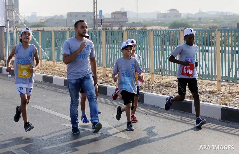 Palestinian children take part in a marathon to mark the International Youth Day, in Gaza city, on Aug. 12, 2016. Photo by Mohammed Asad