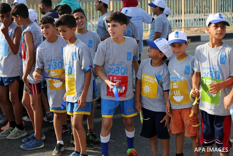 Palestinian children take part in a marathon to mark the International Youth Day, in Gaza city, on Aug. 12, 2016. Photo by Mohammed Asad