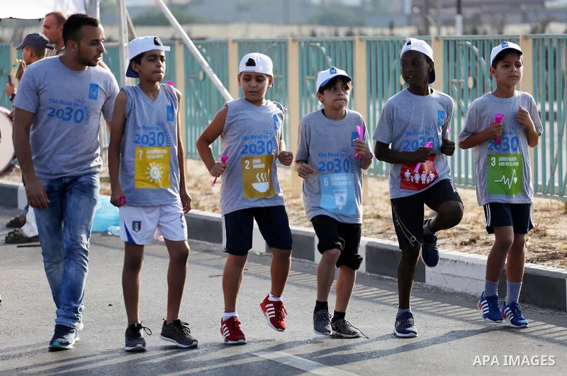Palestinian children take part in a marathon to mark the International Youth Day, in Gaza city, on Aug. 12, 2016. Photo by Mohammed Asad