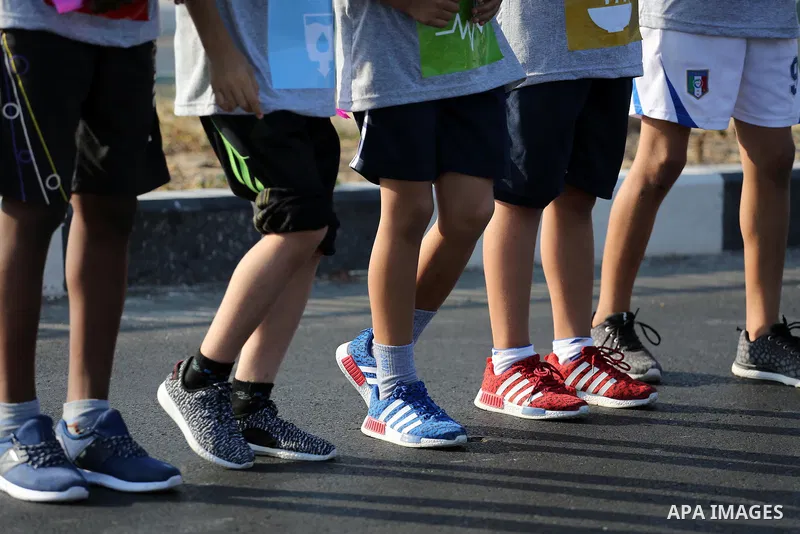 Palestinian children take part in a marathon to mark the International Youth Day, in Gaza city, on Aug. 12, 2016. Photo by Mohammed Asad
