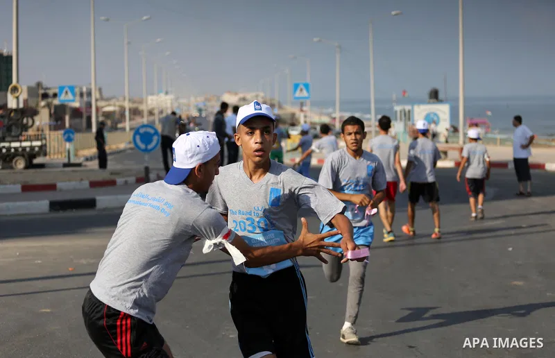 Palestinian youths take part in a marathon to mark the International Youth Day, in Gaza city, on Aug. 12, 2016. Photo by Mohammed Asad