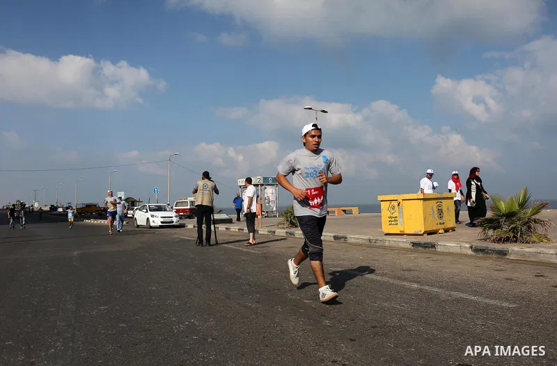 Palestinian youths take part in a marathon to mark the International Youth Day, in Gaza city, on Aug. 12, 2016. Photo by Mohammed Asad